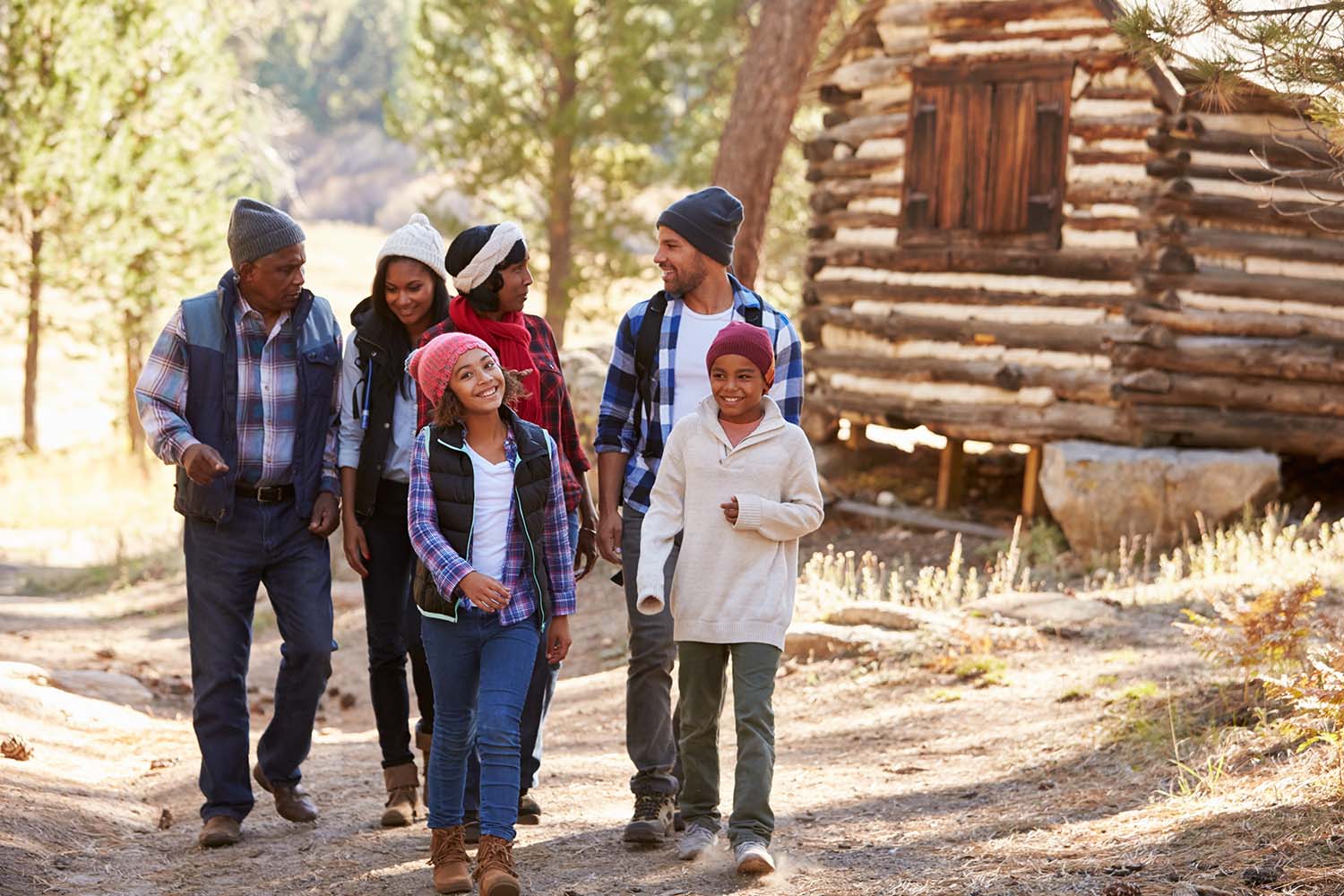 Extended Family Group On Walk Through Woods In Fall